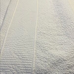 White on white ferns and flowers pattern. 90 inches wide by 89 inches long.